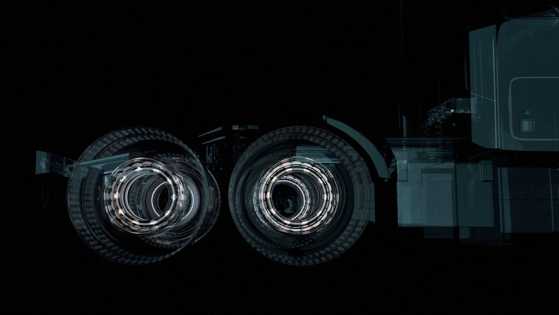 A surreal image of a truck with glowing wheels against a dark background. The wheels appear to spin, creating an abstract, futuristic effect with circular light patterns. The truck's outline is partially visible in shadow.