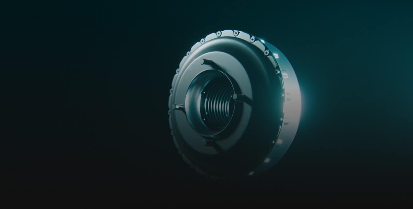 A metallic, circular mechanical component with bolts around the edge is illuminated against a dark background, giving a futuristic, industrial appearance.