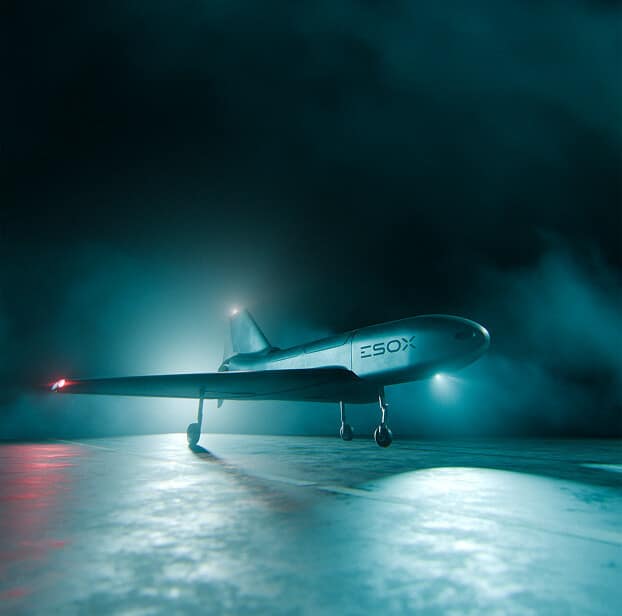 A sleek, futuristic aircraft labeled "ESOX" stands on a misty, illuminated runway at night, surrounded by dramatic blue-green lighting and fog.
