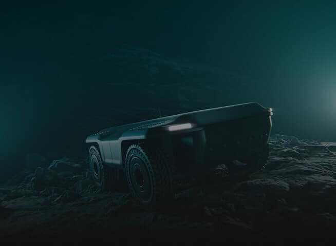 A futuristic, rugged, four-wheeled robotic vehicle is parked on rocky terrain in a dimly lit, misty environment with two bright lights shining in the background.