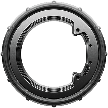 A circular metallic object with a rim-like design, featuring several screws and a smooth, sleek appearance. The center is open, resembling a gear or mechanical component. The background is black.