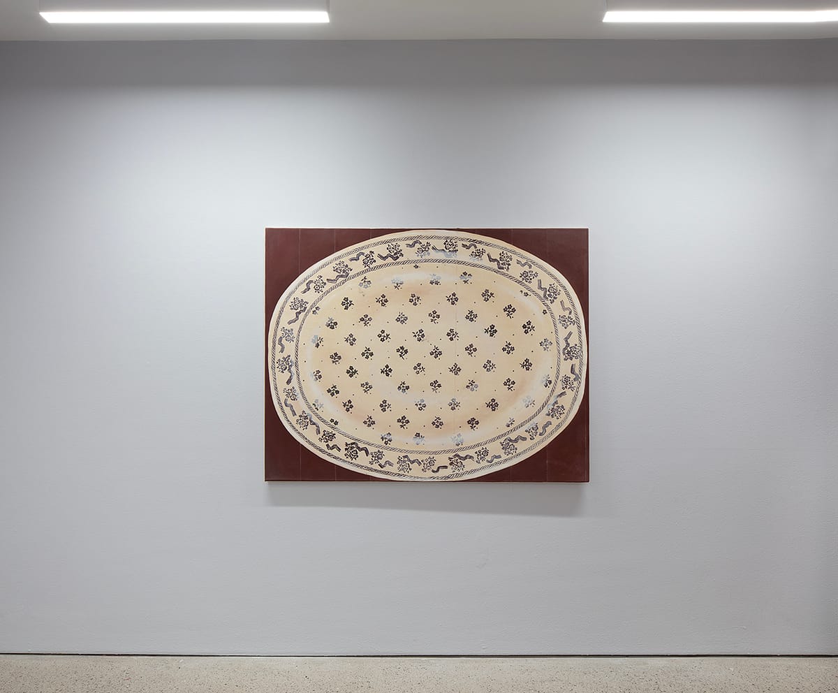 Installation view of ‘Iiris Riihimäki: Tea Bladder’ with the painting Mother’s Lore (2024) showing a stencilled Laura Ashley plate on a painted table. 