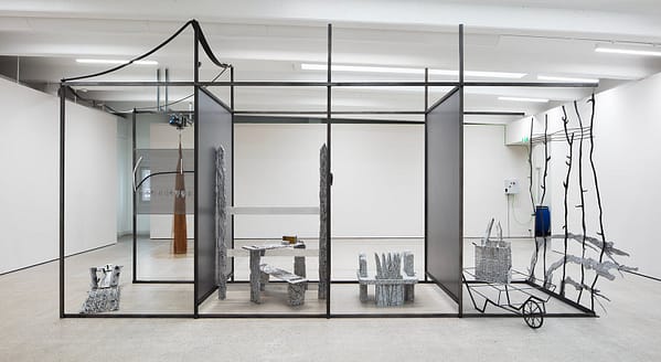 general view of the exhibition with a large metal structure in the gallery space