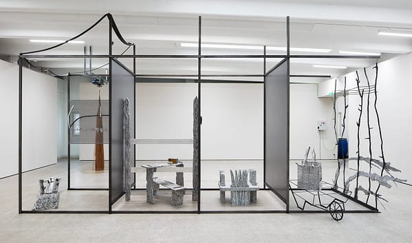 general view of the exhibition with a large metal structure in the gallery space