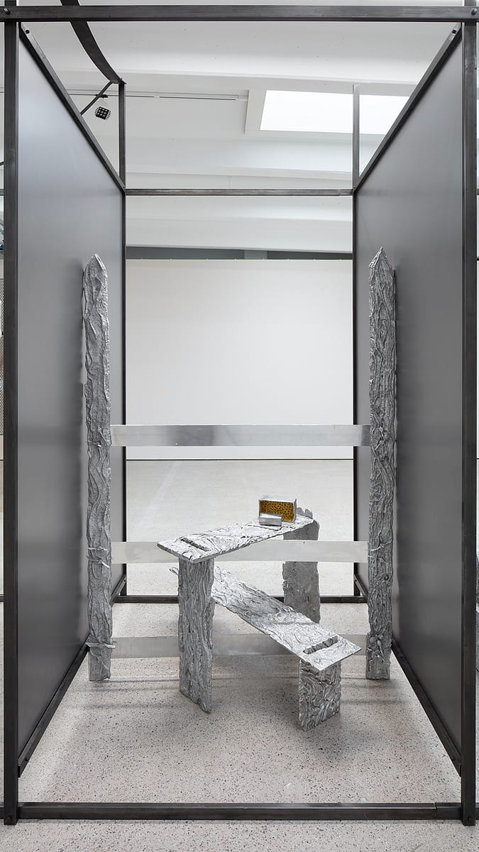 Detail of the large aluminium work by Maija Fox. A cubicle articulated with patinated steel profiles and sheets.
