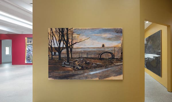 Installation view from the exhibition "Thomas Nyqvist: Painovoima" with a landscape painting of a building site called "Group" hanging on a yellow wall.