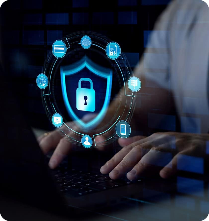 Hands typing on a laptop keyboard with a digital graphic overlay of a shield and padlock, surrounded by security and technology icons, symbolizing cybersecurity.