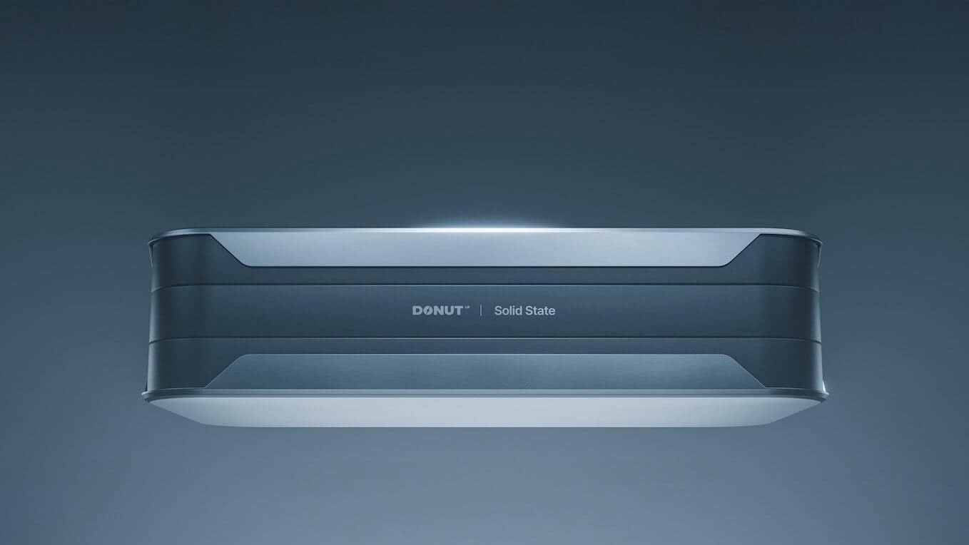 A sleek, rectangular electronic device labeled "DONUT | Solid State" is shown against a plain, gradient blue background, viewed from a slightly lower front angle.