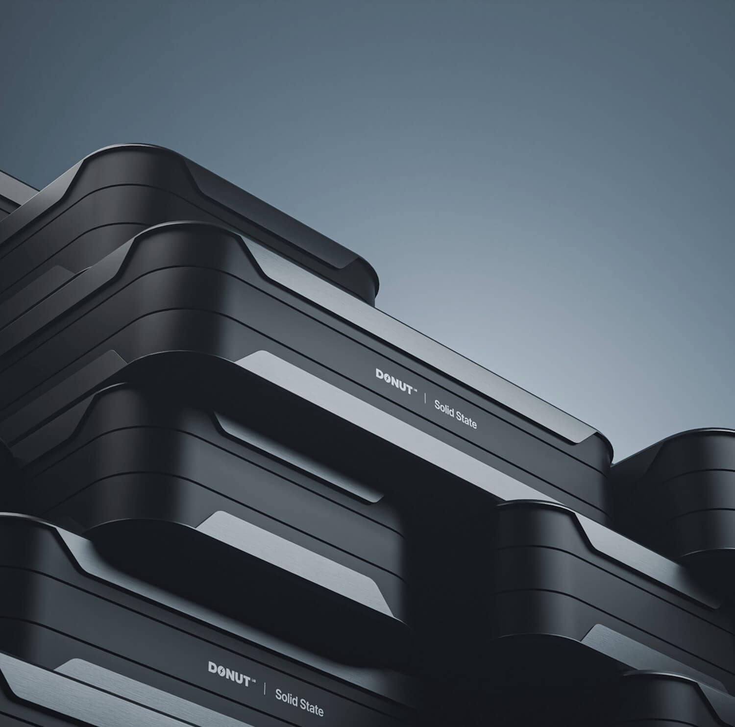 Stacked black and gray rectangular devices labeled “DONUT | Solid State” against a gradient blue background. The objects have smooth, modern edges and are arranged diagonally in the frame.