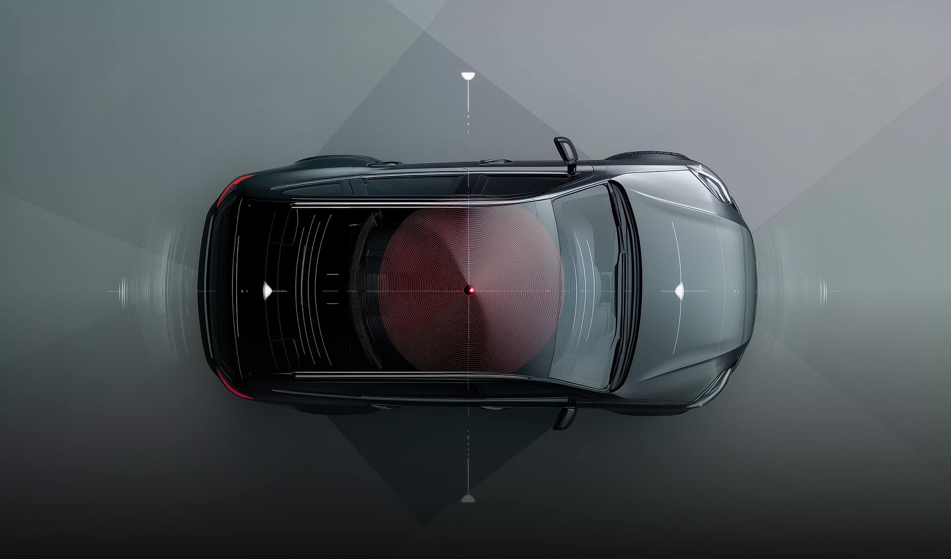 Overhead view of a black car on a gray background with radar-like graphics indicating sensor or detection fields around the vehicle, highlighting technology for navigation or safety systems.