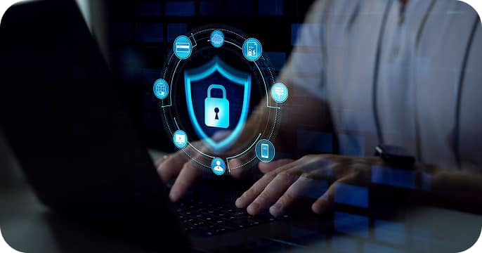 Person typing on a laptop with a digital lock and security icons overlay, representing cybersecurity and data protection.