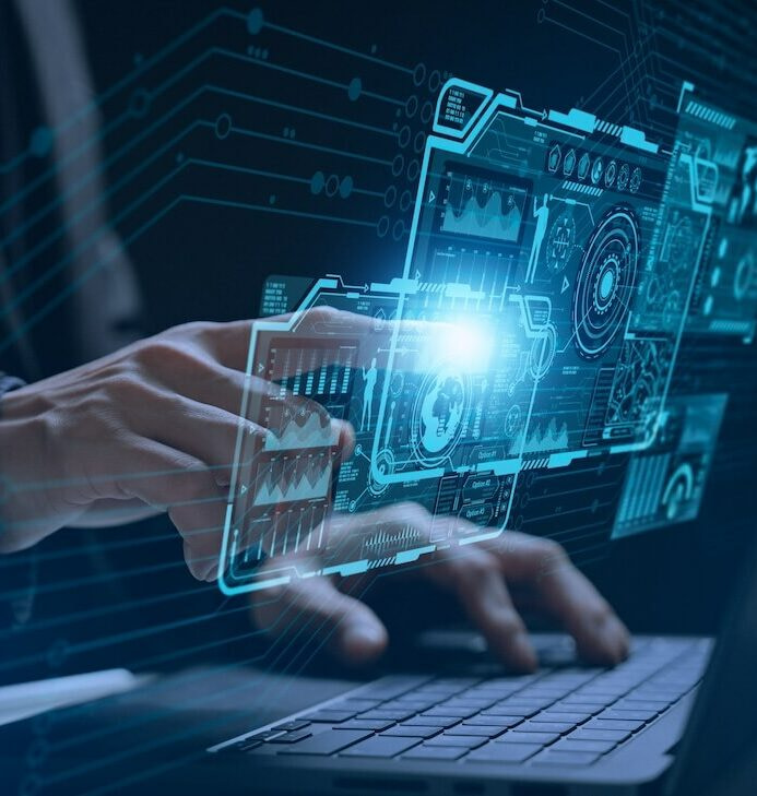 Phase 6 Final Optimization and Launch Hands typing on a laptop keyboard with glowing blue digital holograms of various technical interfaces and diagrams projected above the keys, symbolizing advanced technology and innovation.