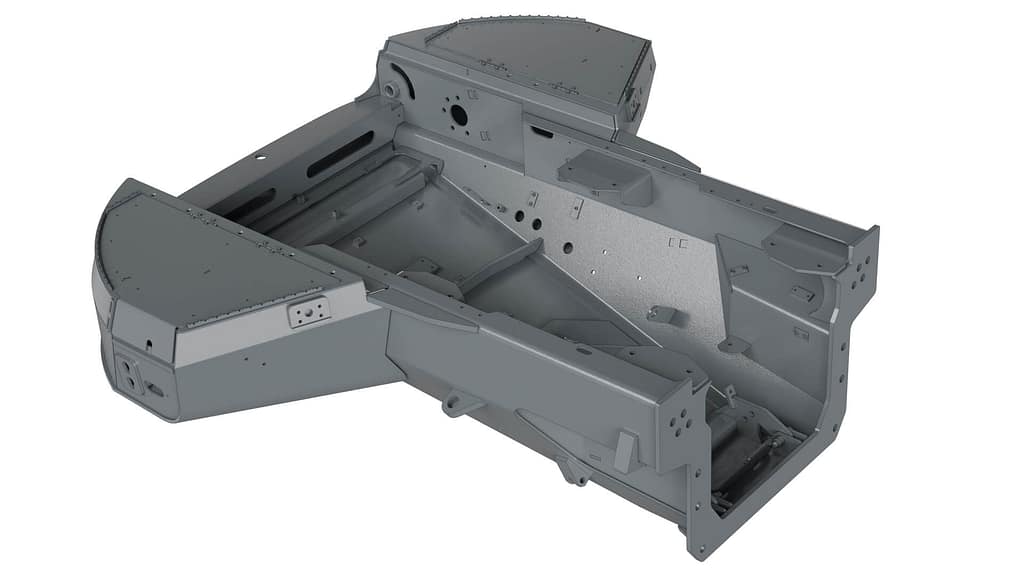 3D-rendered image of a gray, metal vehicle chassis component with angular, boxy sections and various cutouts, holes, and attachment points. It appears to be designed for structural support.