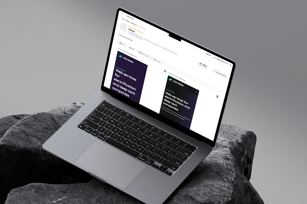 A laptop sits on a stone surface, displaying a website with text about AI for tech companies. The screen shows two cards with similar text and a clean, modern layout.