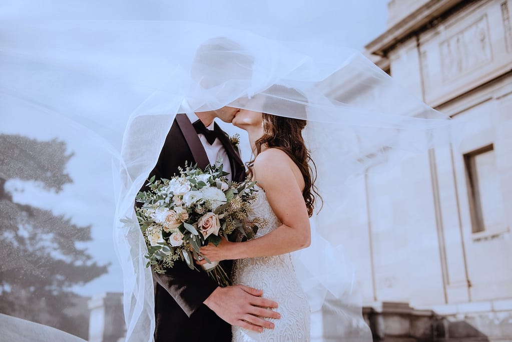 A couple kissing on their marriage