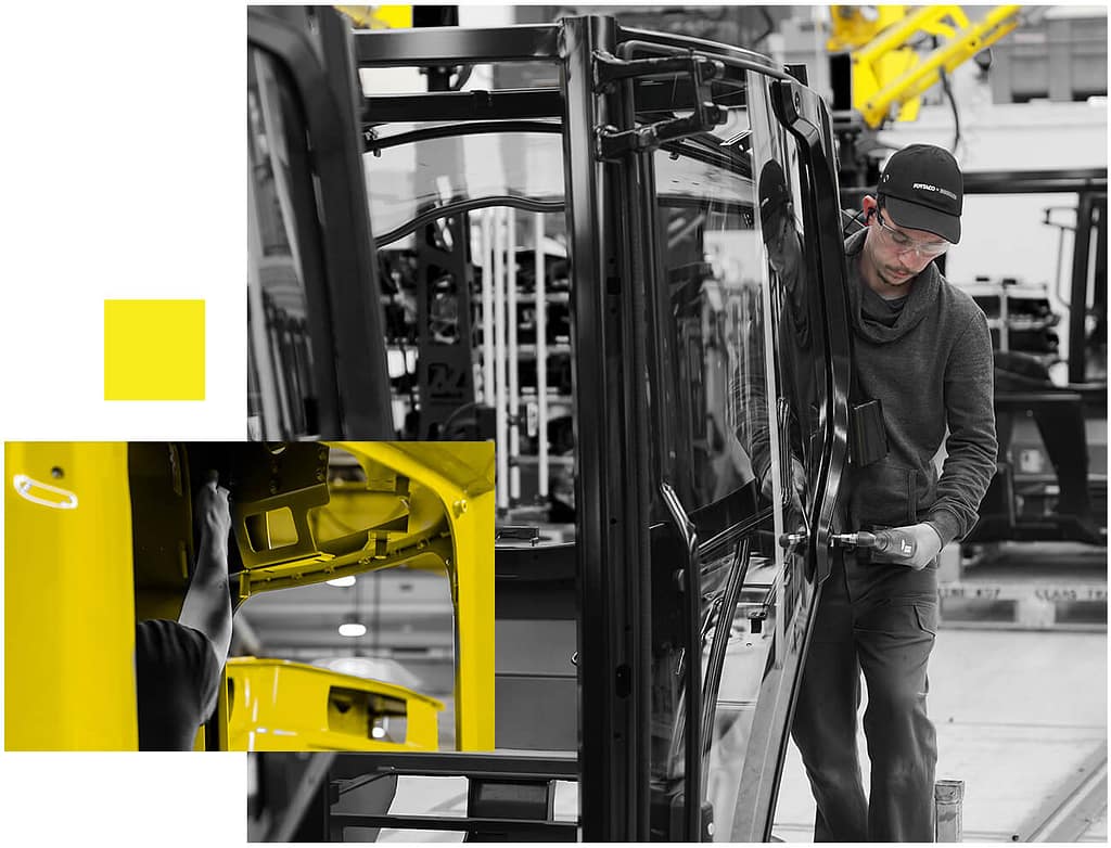 A black and white photo of a man working on a yellow truck.
