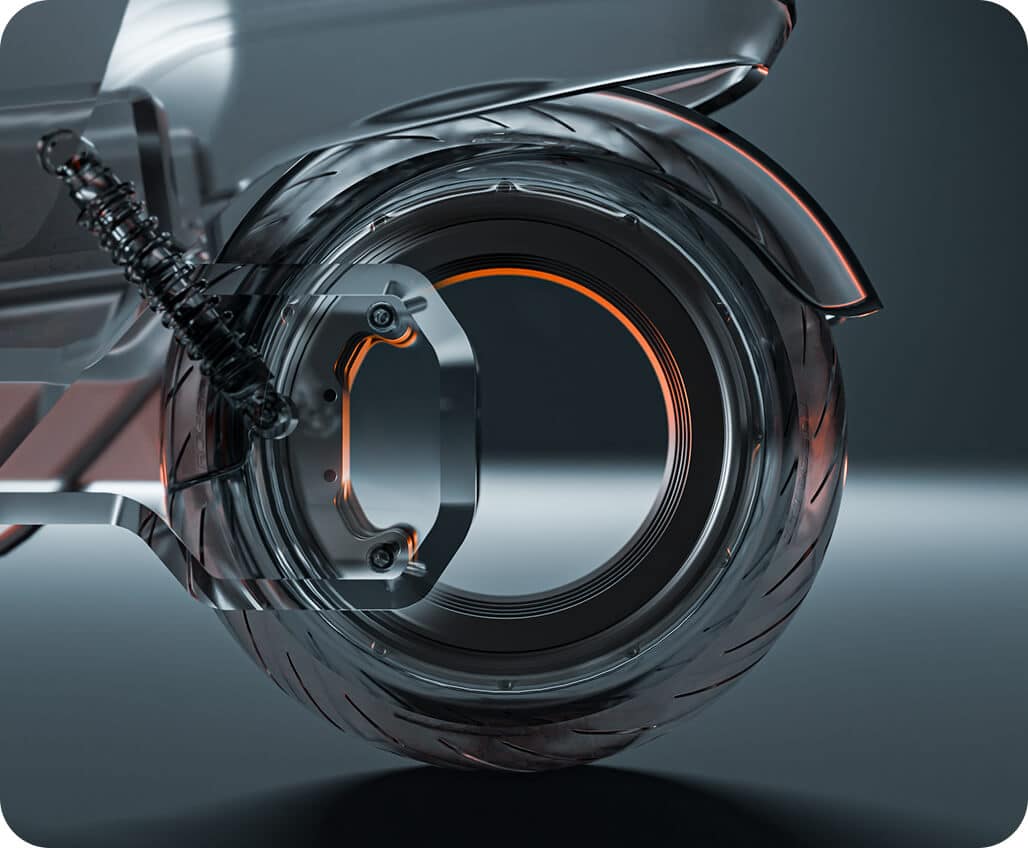 A close-up view of a futuristic, transparent motorcycle wheel with visible treads, metallic orange accents, and a suspension spring against a dark background.