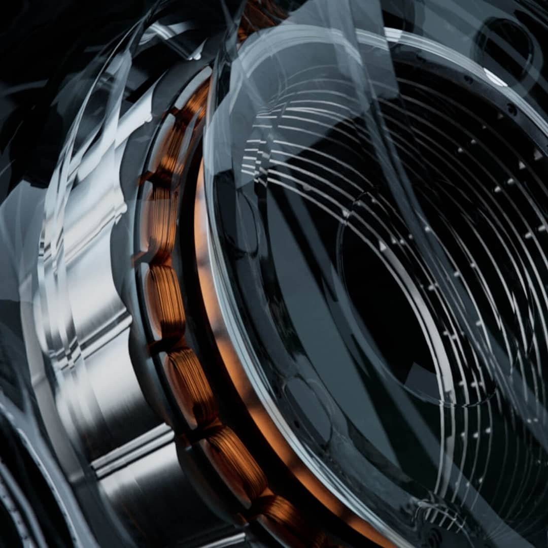 donut-motor-square Close-up image of an intricate mechanical component featuring metal coils and circular layers. The design includes copper elements and reflective surfaces, creating a complex industrial appearance with a mix of metallic and dark tones.