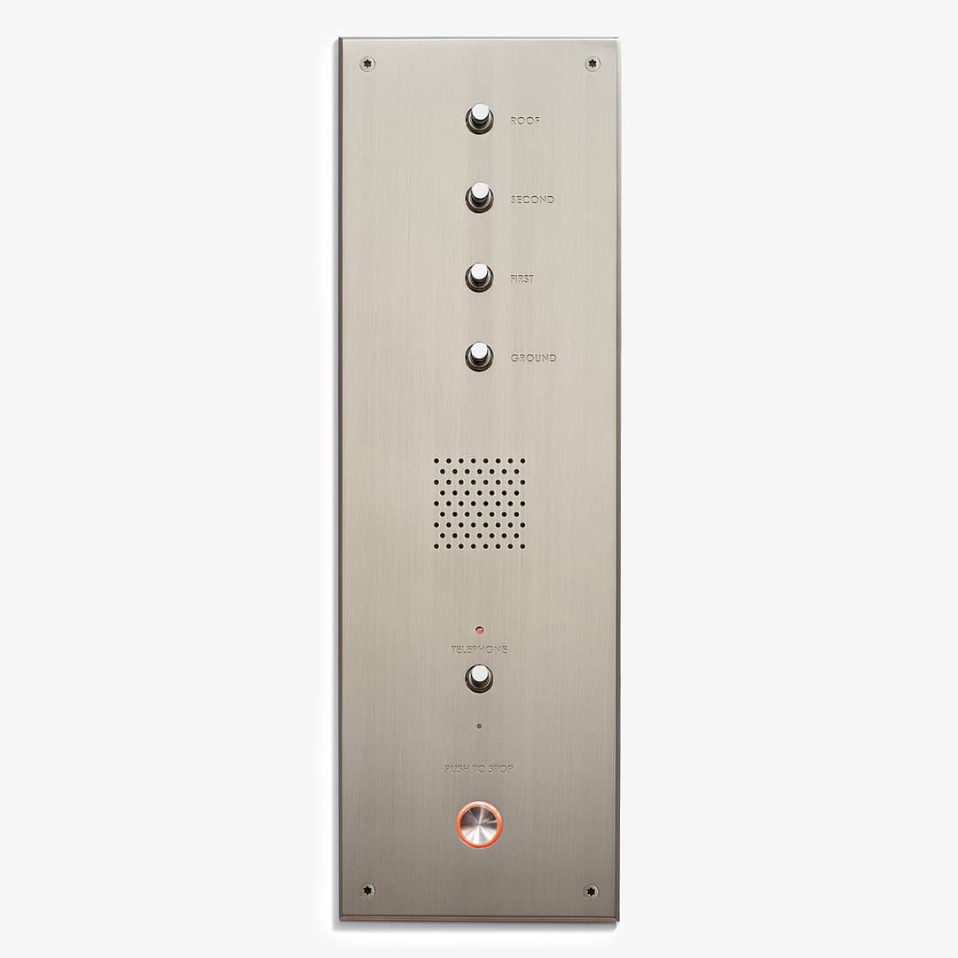 Silver intercom panel with multiple buttons labeled "101," "102," "second," "third," and a microphone grille, along with led indicators and a "press to exit" button with wheelchair symbol.