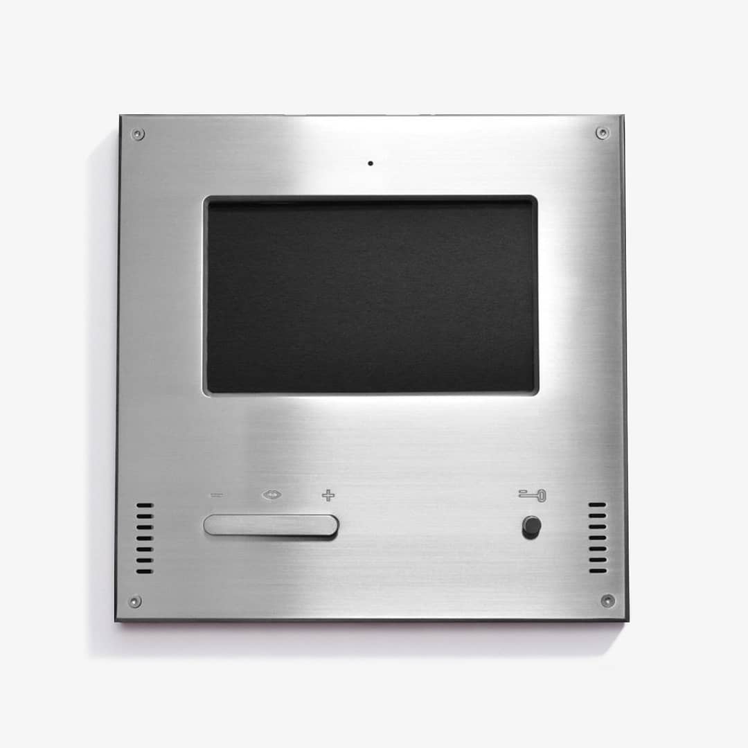 Modern stainless steel intercom system with display screen on a white background.