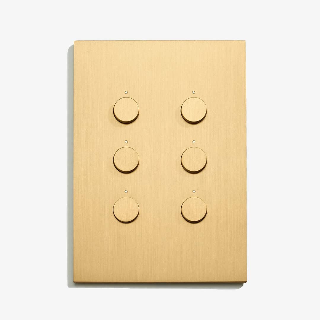 A light switch with four buttons on a white surface.