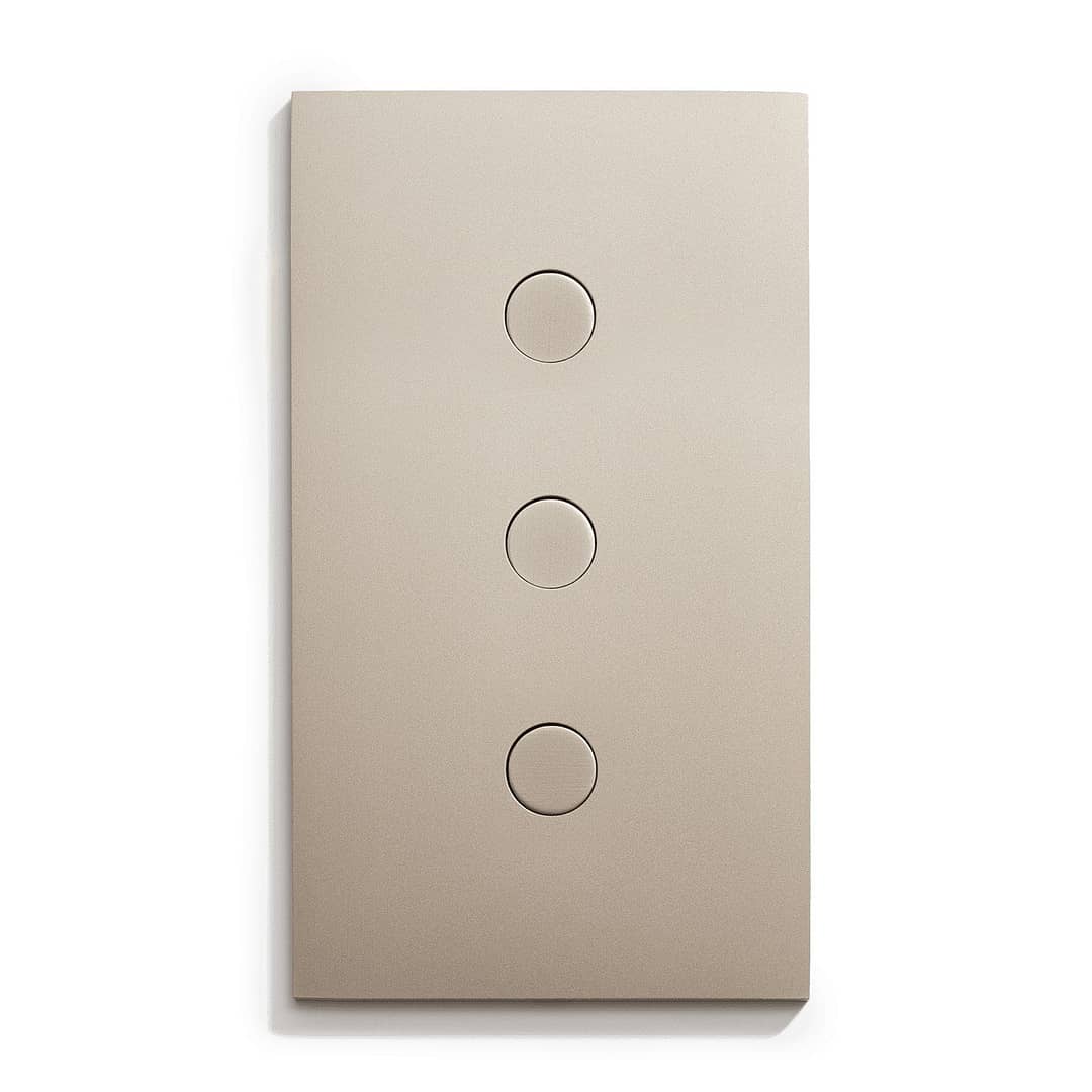 A light switch with three buttons on a white surface.