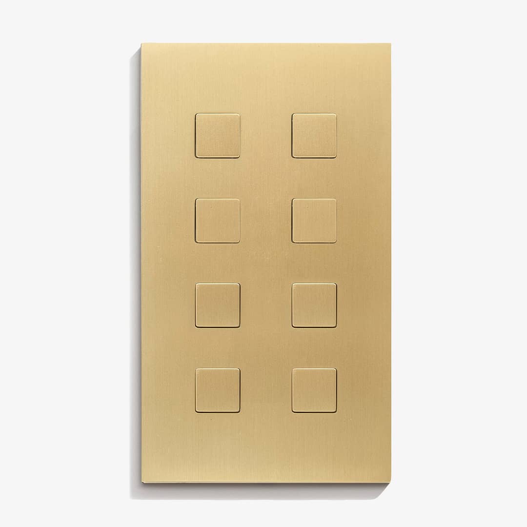 A brass plate with four squares on it.
