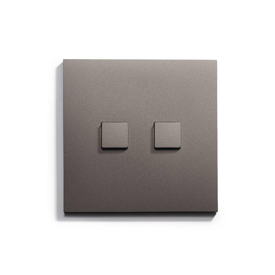 A light switch with two squares on a white surface.