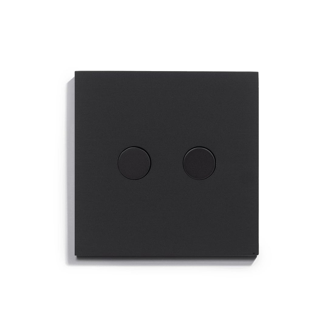 A black light switch on a white surface.