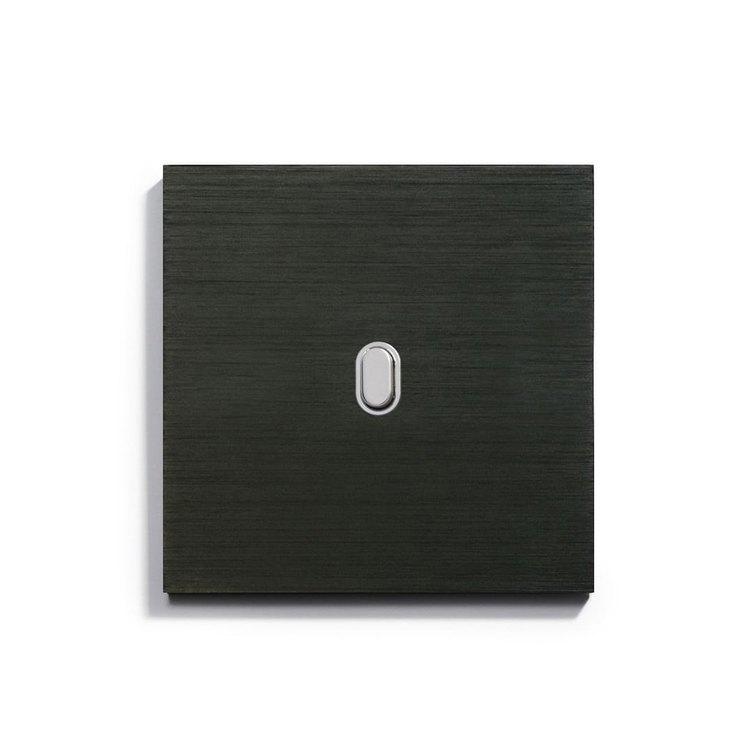 A black light switch on a white surface.