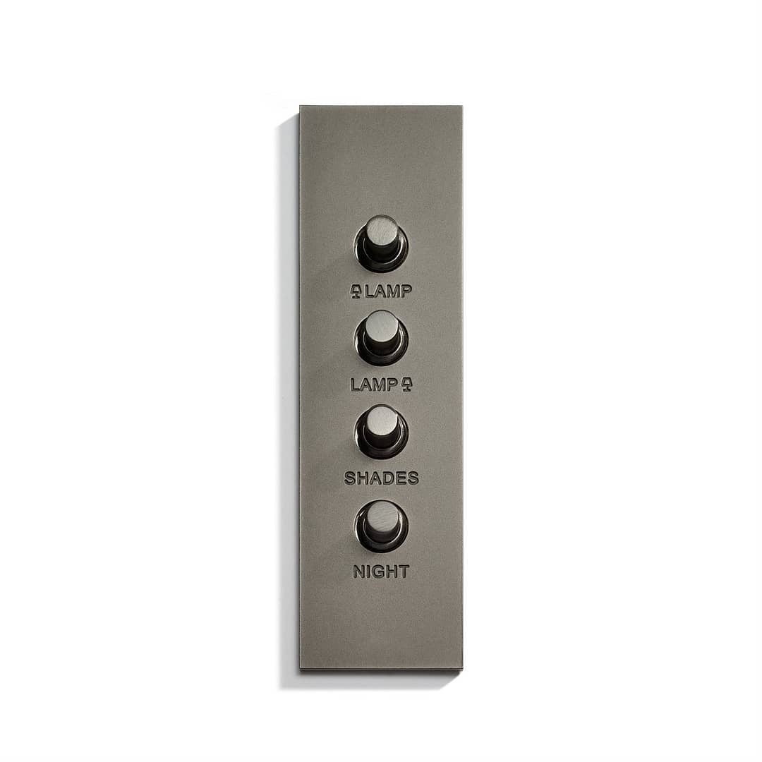 A wall plate with four buttons on it.
