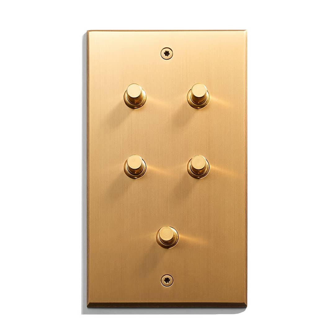 A gold plate with four knobs.