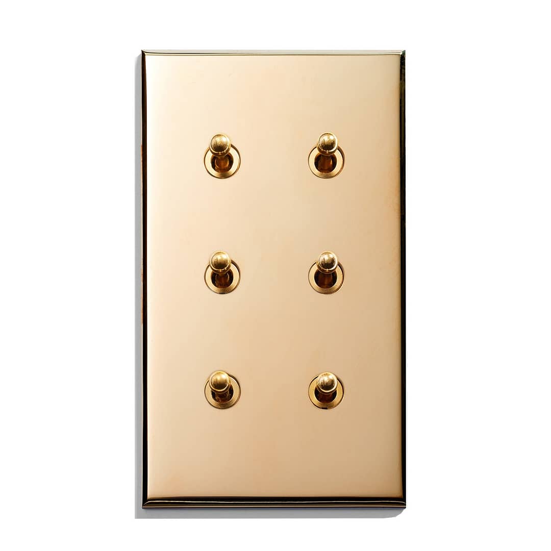 A gold plate with four buttons on it.