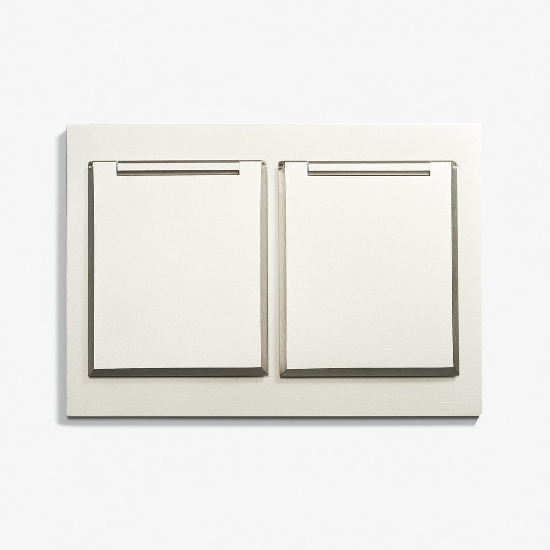 A white wall plate with two switches on it.