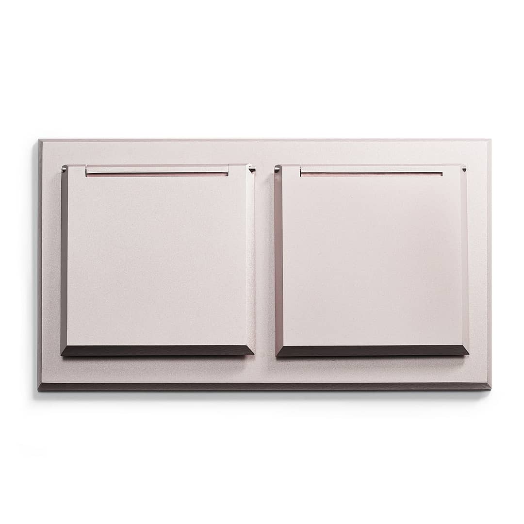 A pink wall mounted shelf with two drawers.