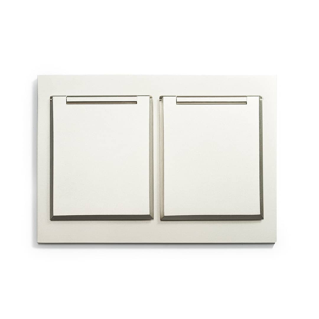 A white wall plate with two switches on it.