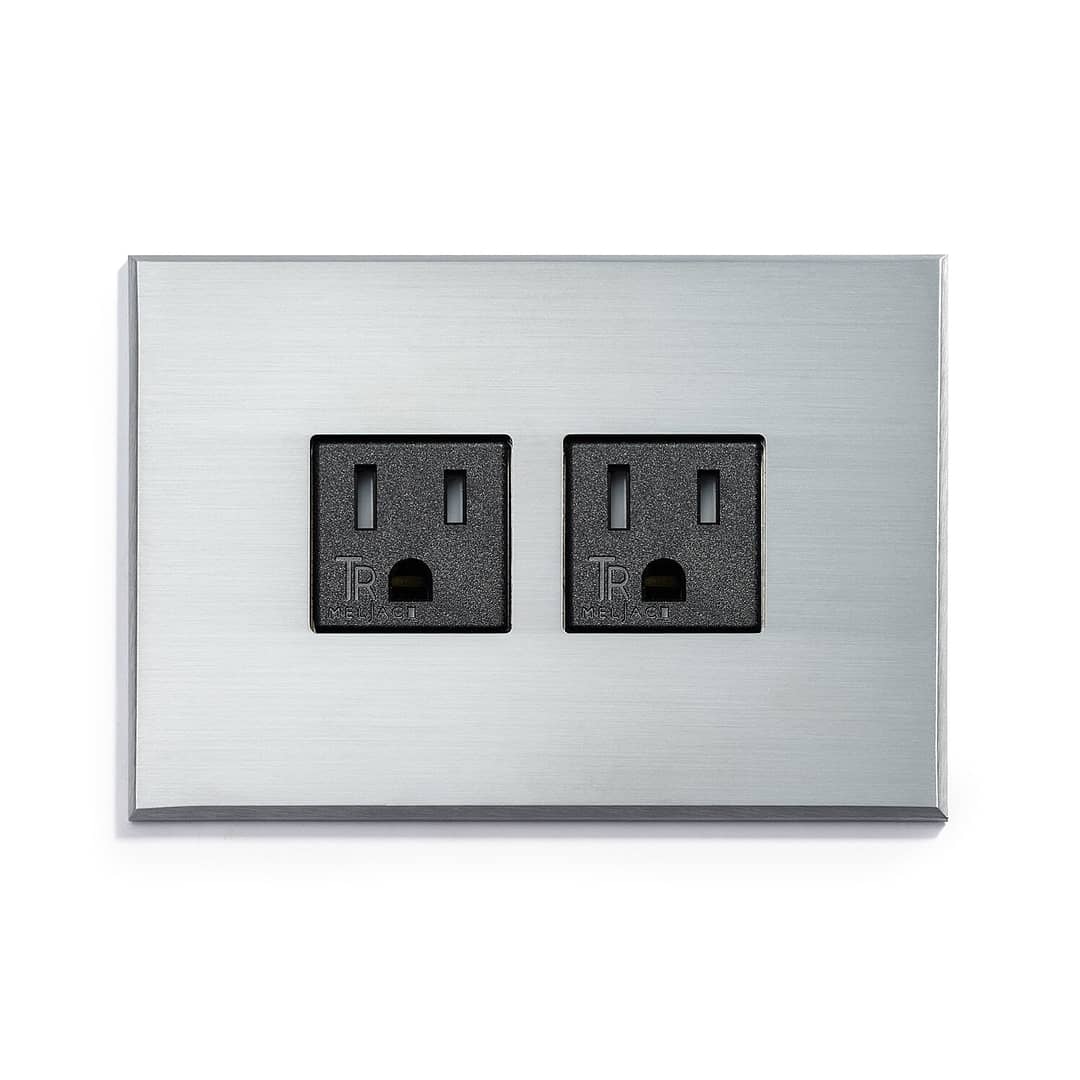 A wall plate with two outlets on it.