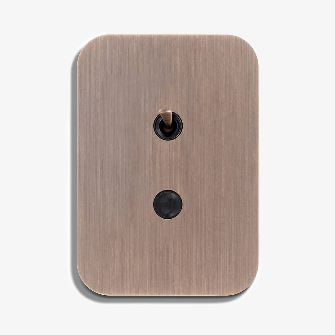 A light switch with a black button on it.