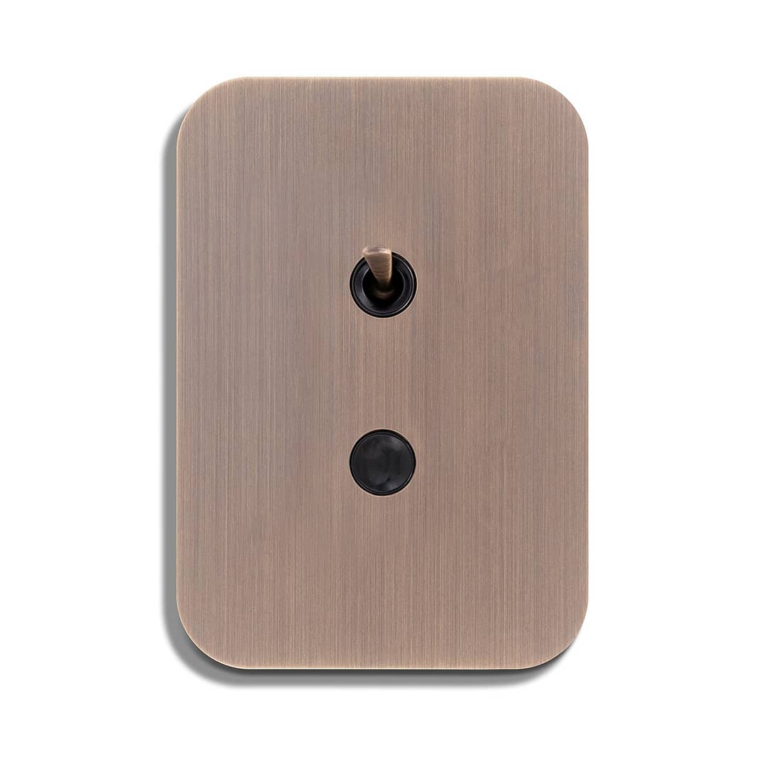 A light switch with a black button on it.