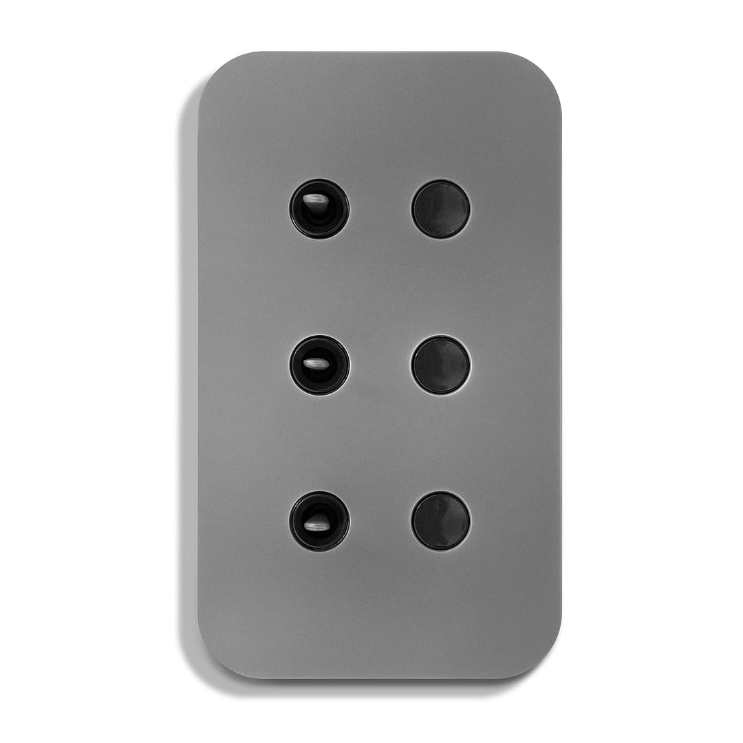 A grey wall plate with four black buttons.