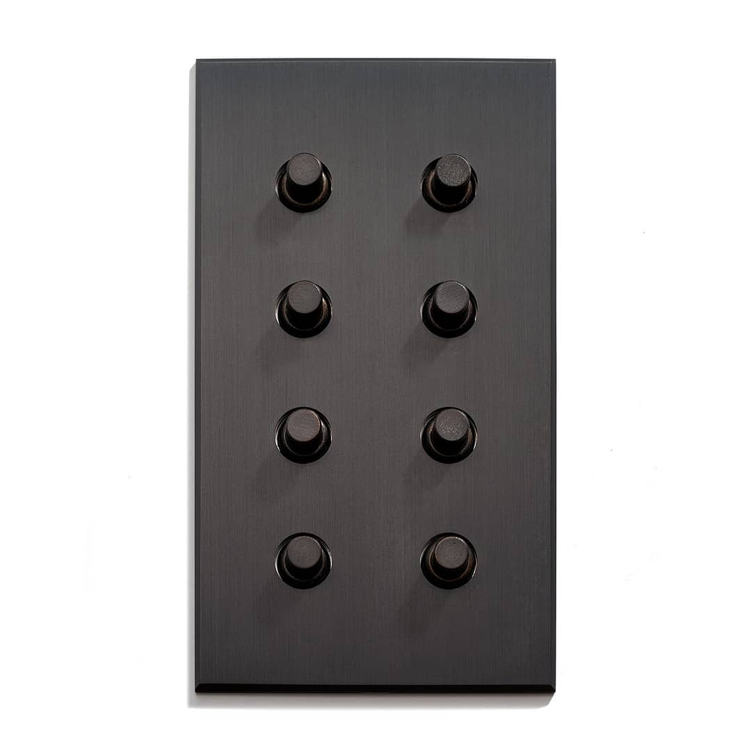 Black panel with an array of nine knobs against a white background.