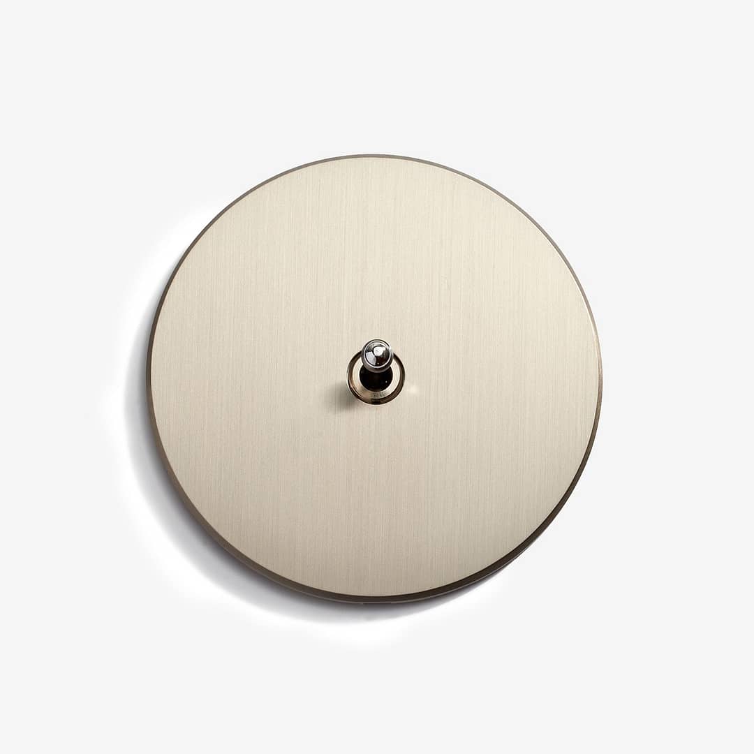 A minimalist view of a round, metal lid isolated on a white background.
