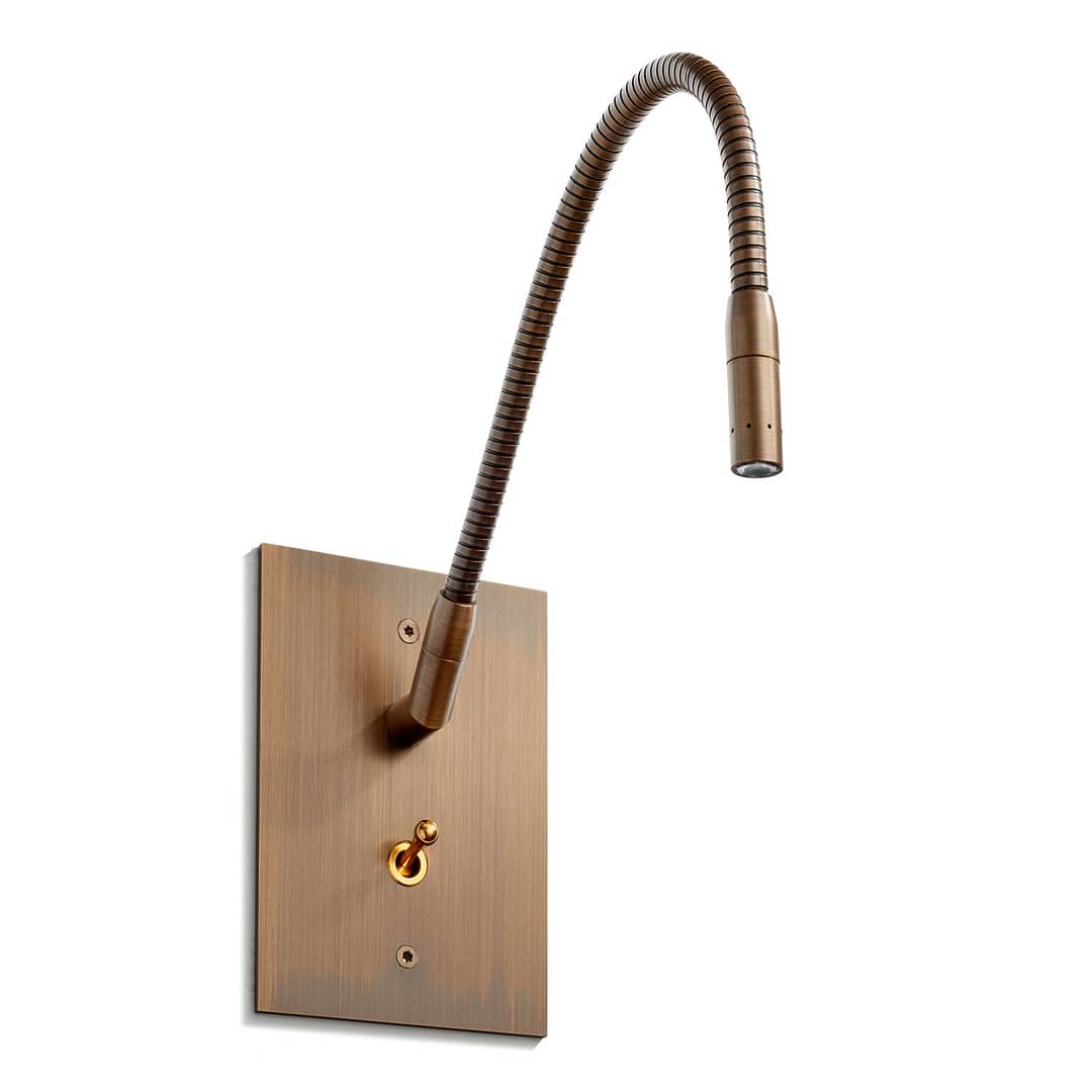 Flexible wall-mounted reading light with adjustable neck on a wooden base.