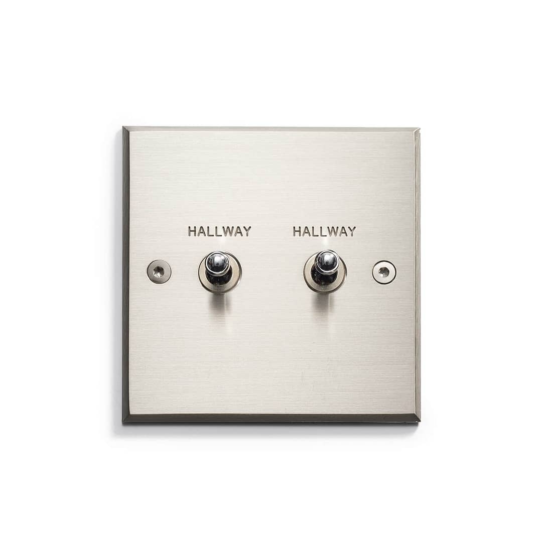 A silver square with three switches.