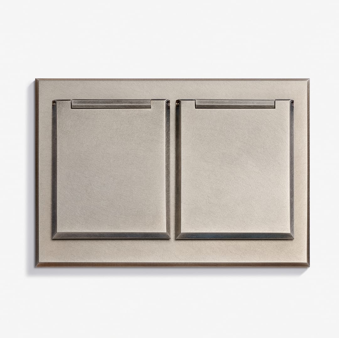 A metallic double light switch panel with two square switches, set against a plain white background.