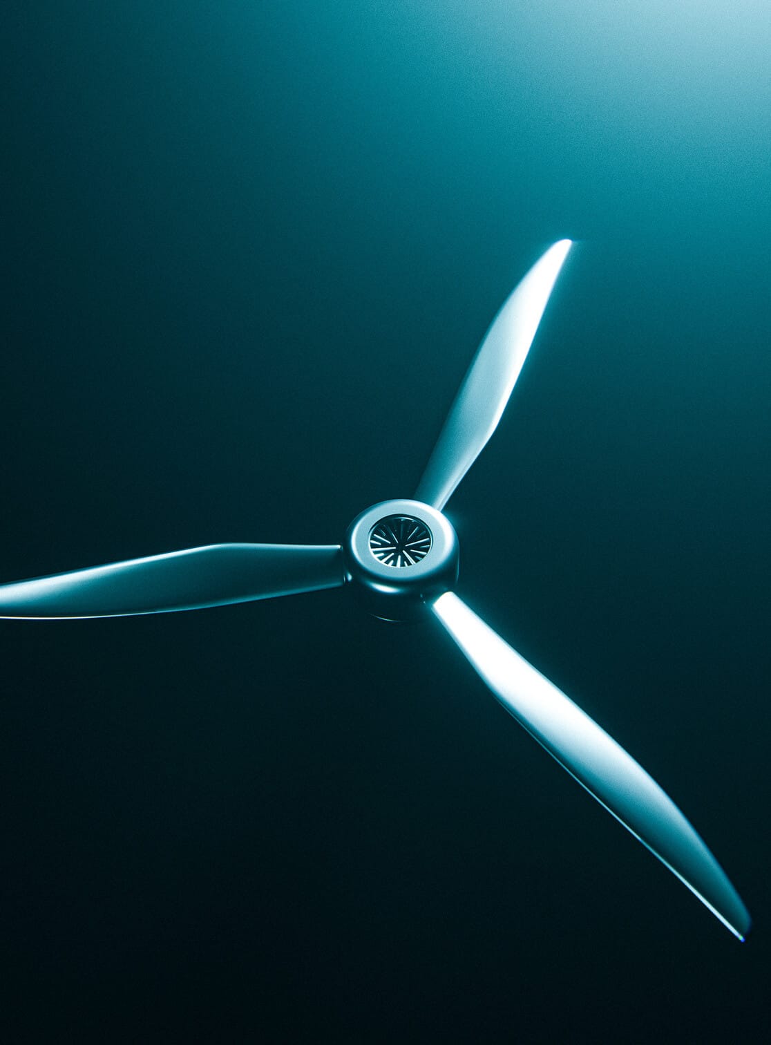 A close-up of a three-blade propeller or turbine, viewed from above against a dark, teal gradient background with light reflecting off the metal blades.