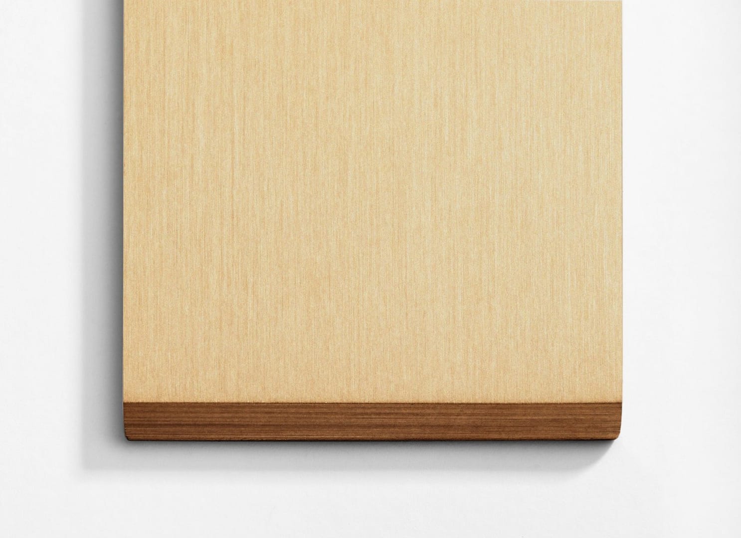 A wooden cutting board on a white wall.