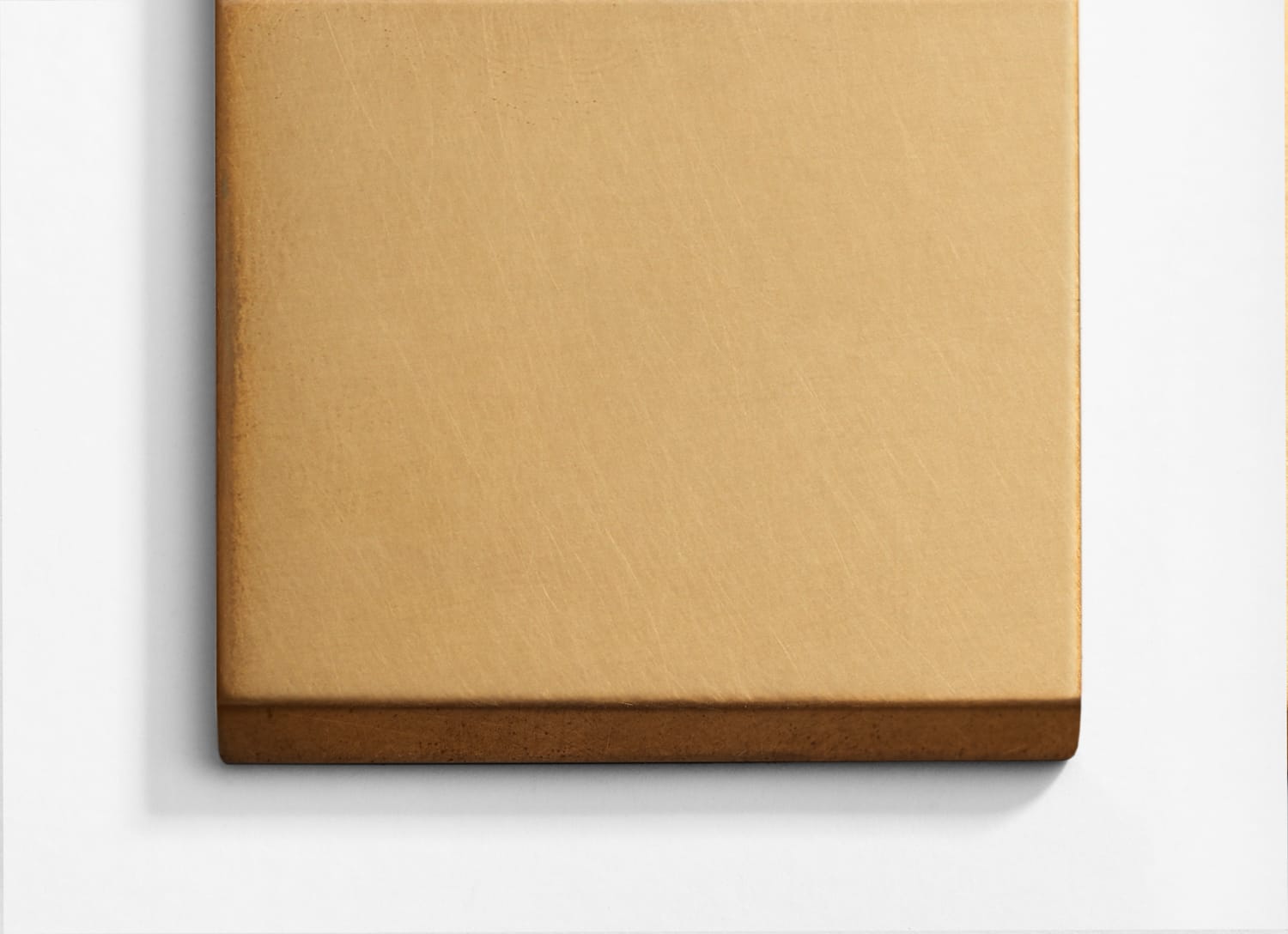 A gold square on a white wall.