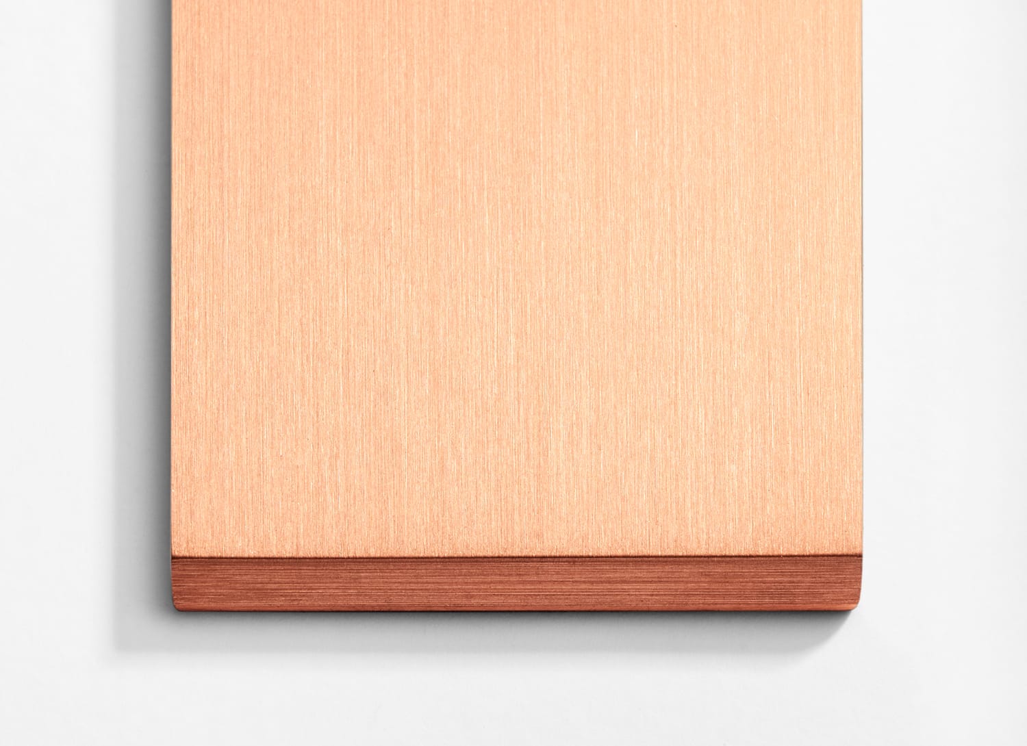 A copper plate on a white surface.