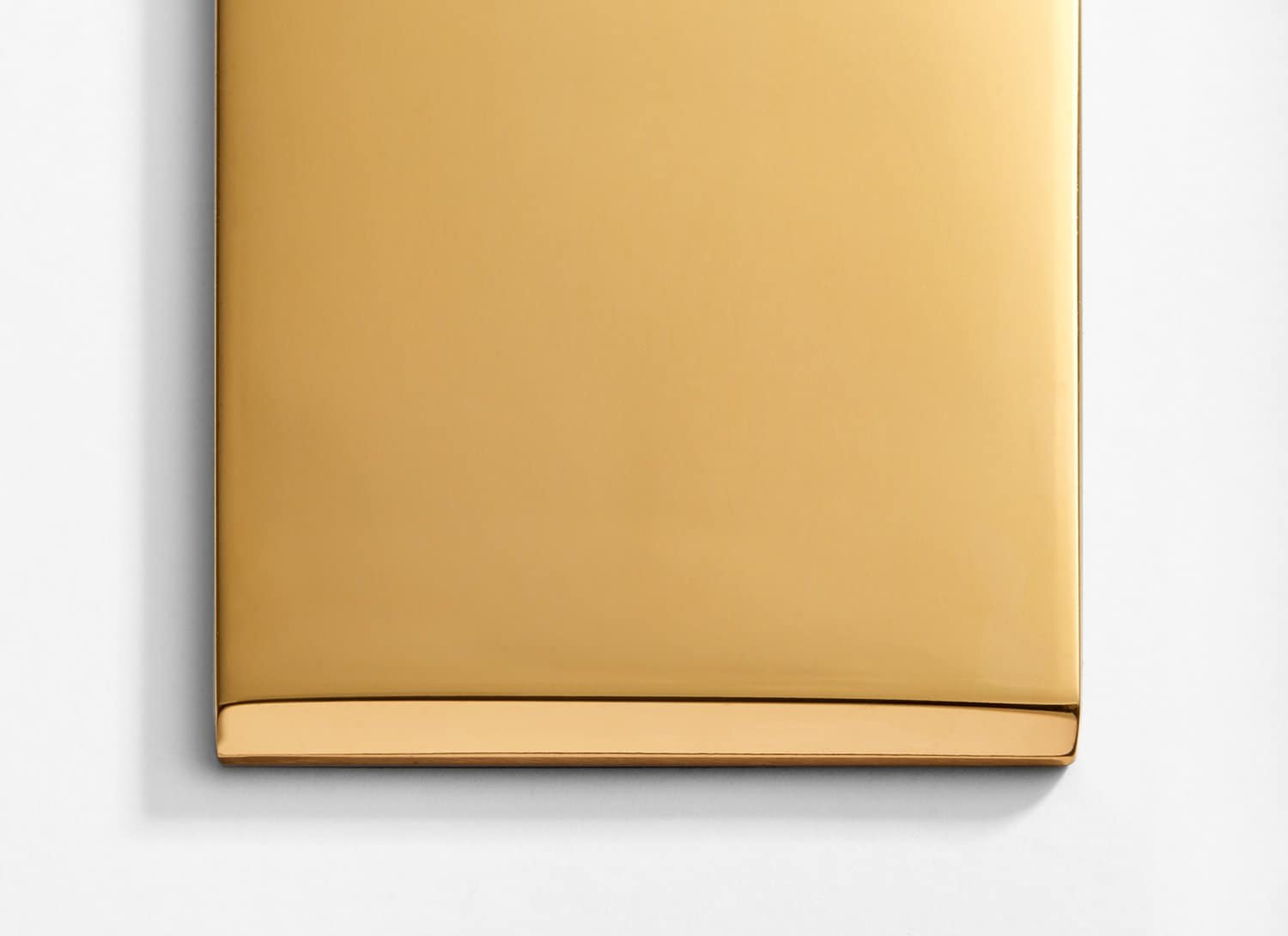 A gold plate on a white surface.